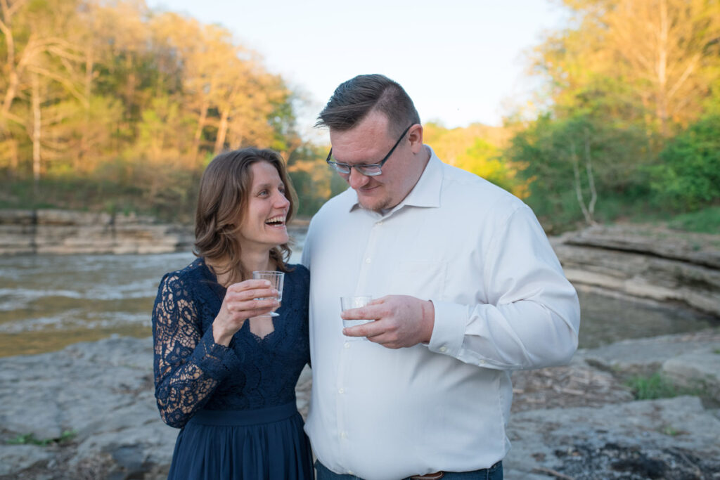 Couple enjoys drinking sparkling water after proposal as a sustainable photo session alternative to champagne pop.