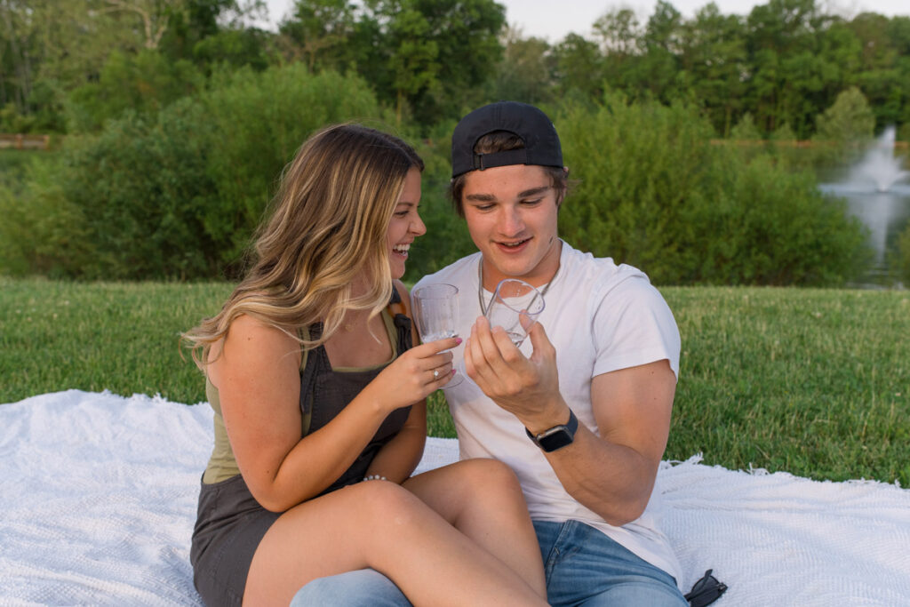 Couple looks at bubbles as they drink sparkling water.