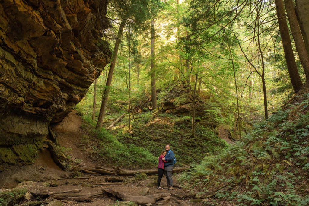 Couple pauses in their hike to take in beauty of sandstone cliffs around them.