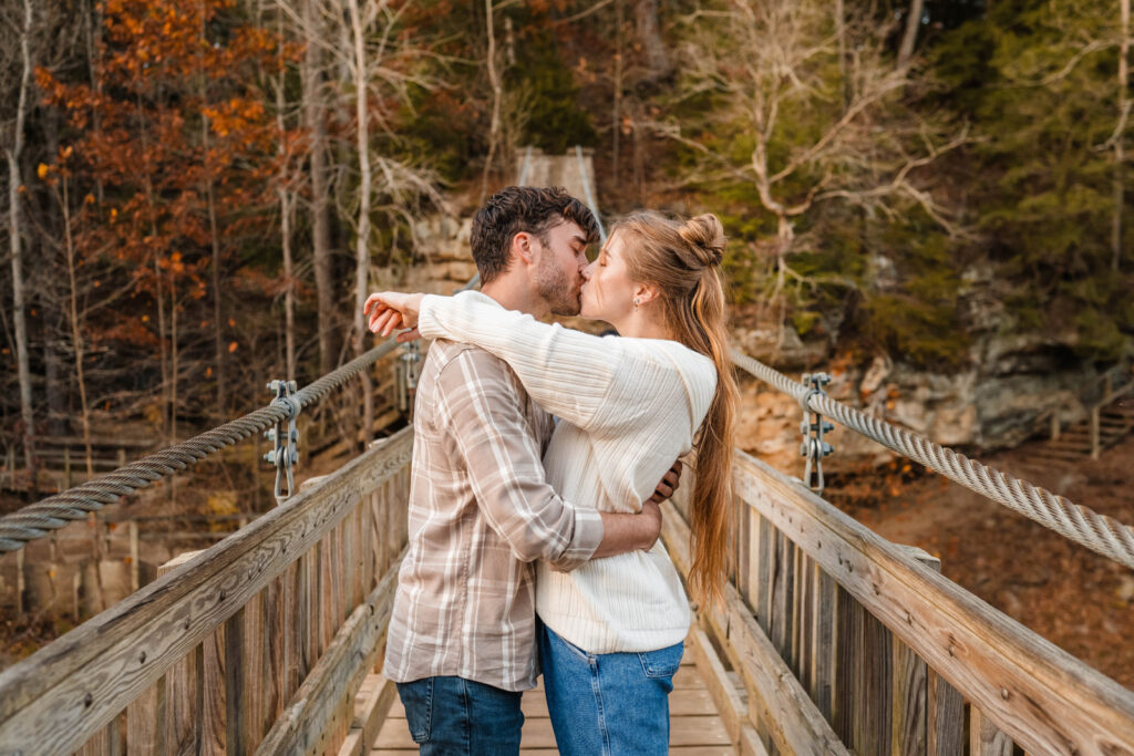 Couple shares a kiss on the suspension bridge at Turkey Run State Park in Indiana.