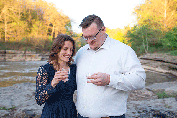 GIF of man and woman toasting to their new engagement with sparkling water.