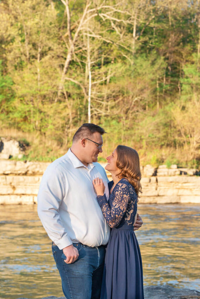 Man proposes to woman during waterfall engagement photos.
