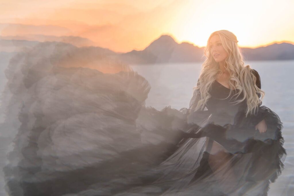 Bride tosses black dress in the air with prism effect at sunset in the Salt Flats.