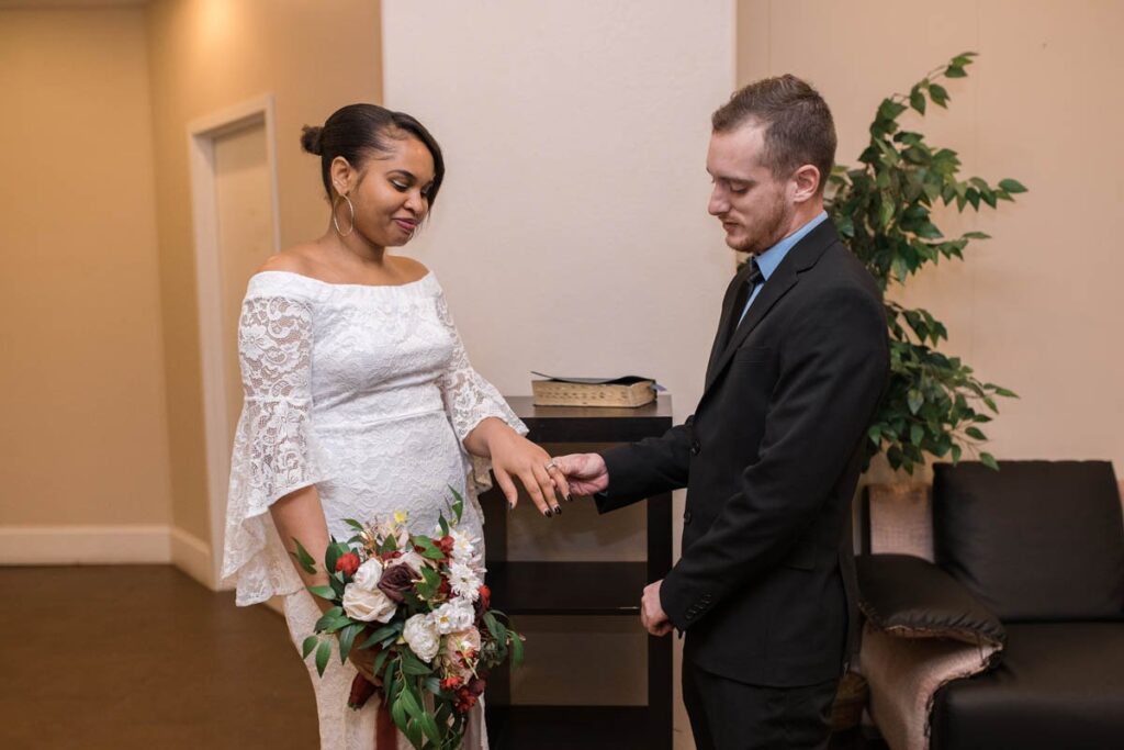 Groom and bride exchange rings at their downtown Indianapolis elopement.