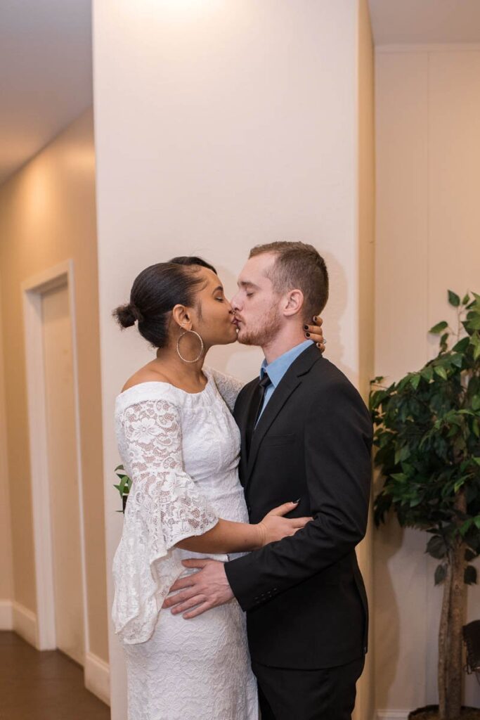 Bride and groom share their first kiss during their elopement ceremony at a chapel in downtown Indianapolis.