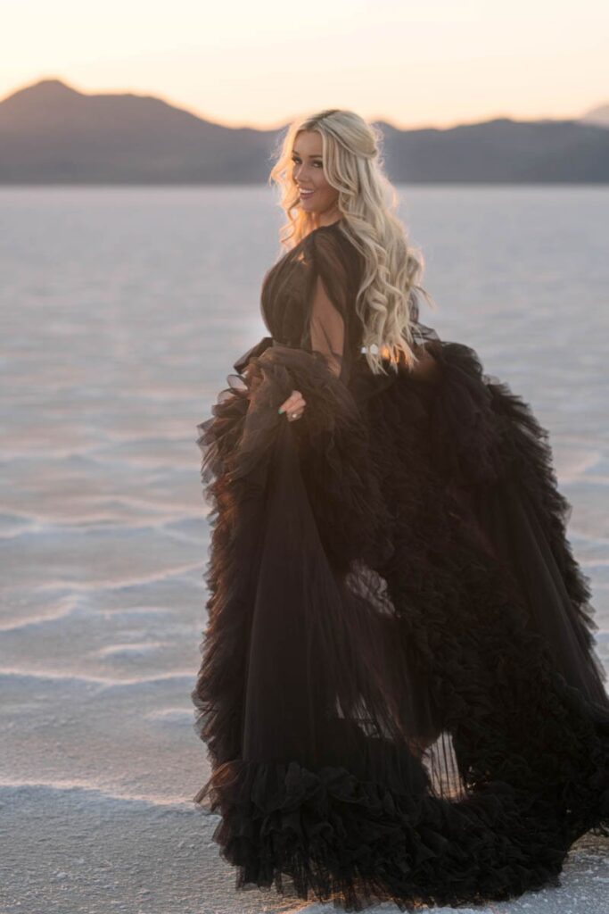 Woman wearing black dress runs barefoot at Salt Flats.