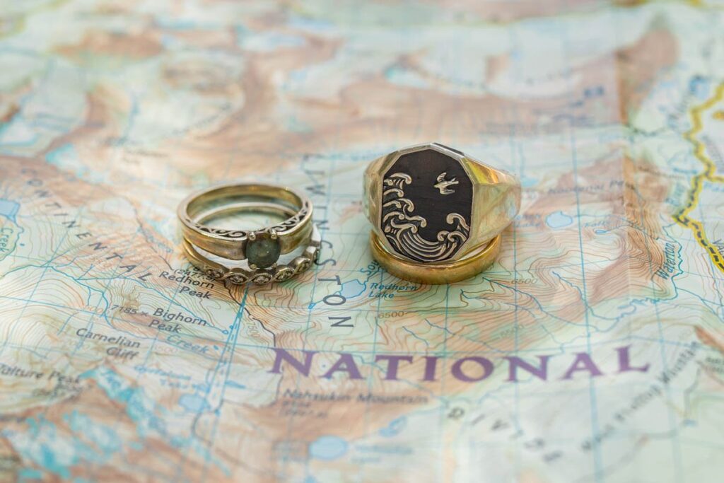 Wedding rings sitting on park map for elopement.