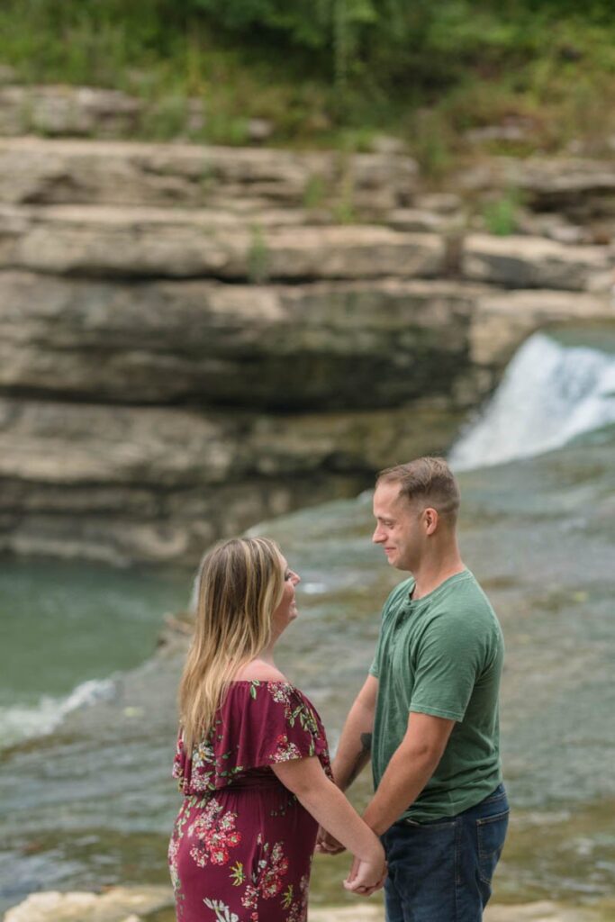 Couple holds hands in an area that overlooks Cataract Falls.