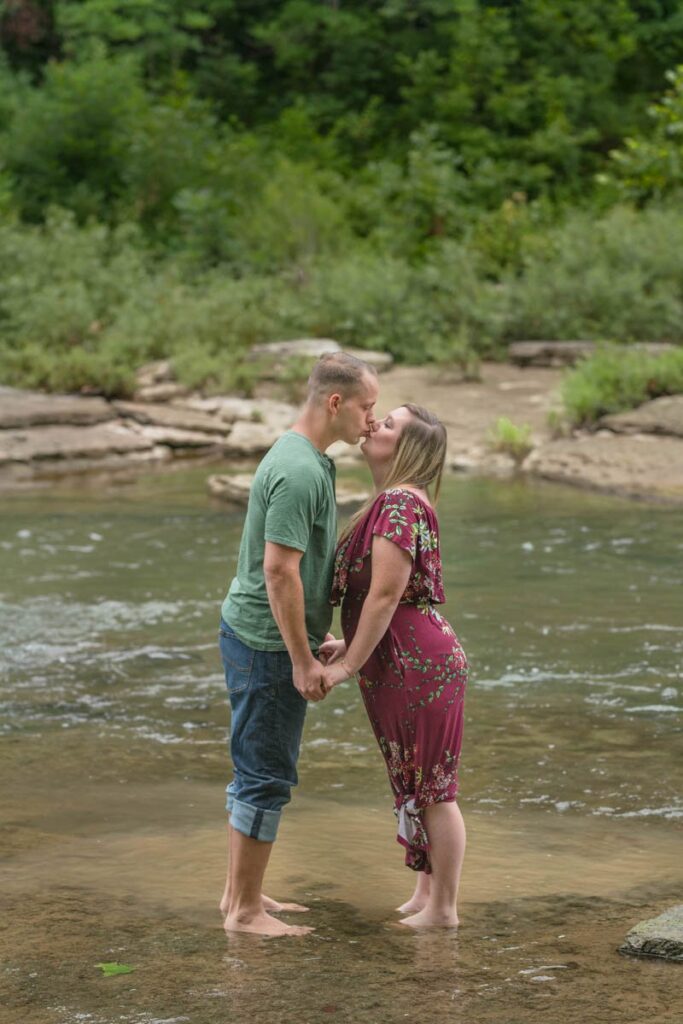 Couple kisses in water at Cataract Falls State Park.