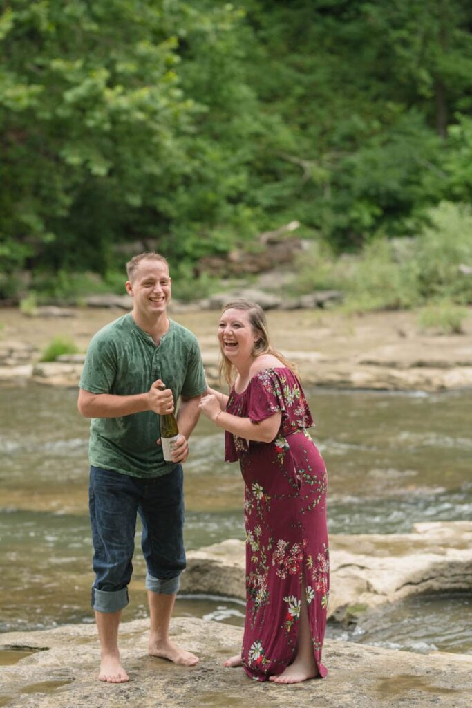 Couple is soaking wet and laughing following sparkling water pop.