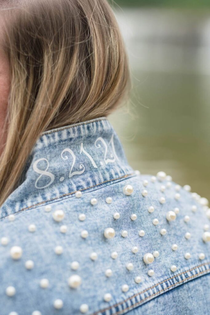 Woman's jeweled jean jacket features wedding date on the collar.