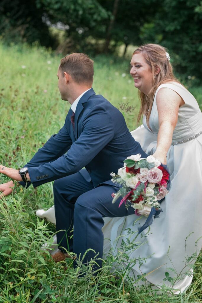 Bride and groom dance in a meadow.