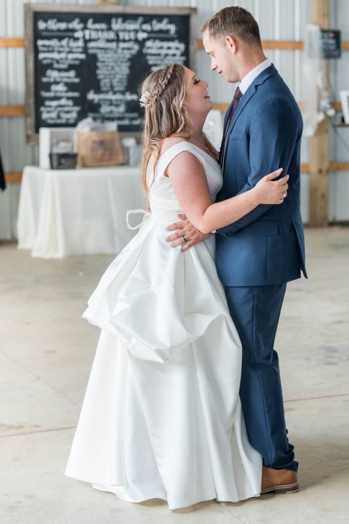 Bride and groom slow dance for their first dance.