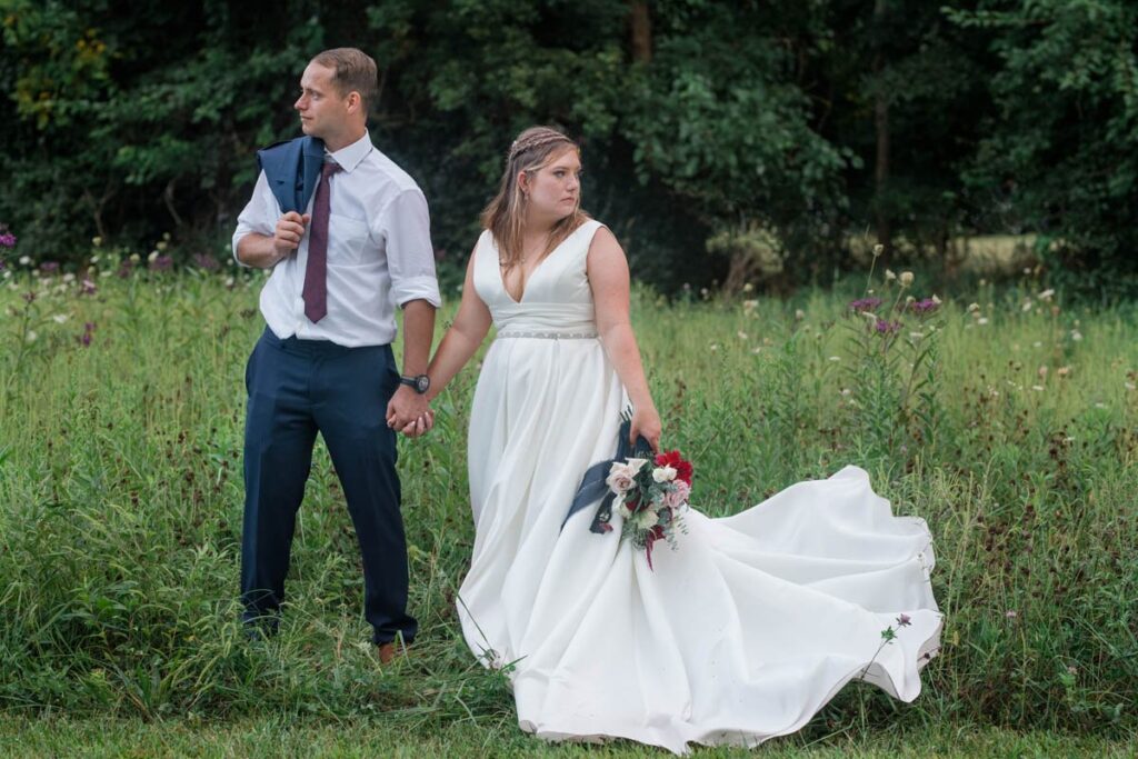Bride and groom are standing in a field of wildflowers following their Indiana outdoor wedding.