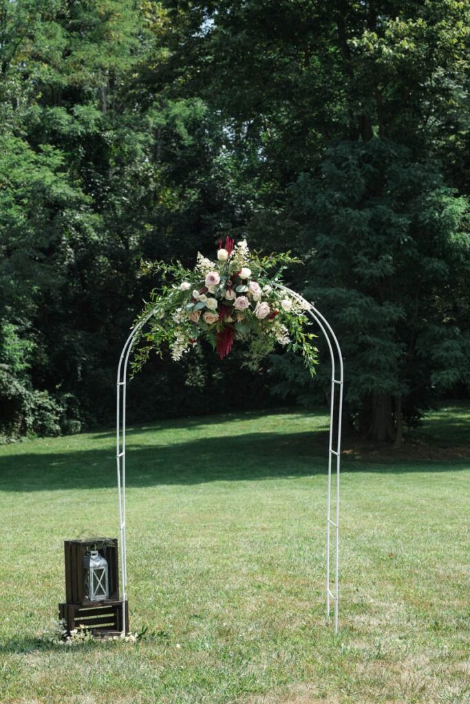Wedding ceremony arch with flowers for an Indiana outdoor wedding.