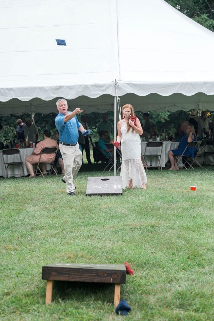 Guests playing cornhole at an Indiana outdoor wedding.