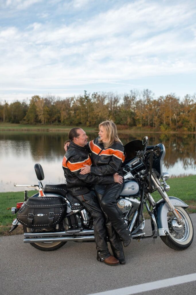 This couple is snuggling up against their Harley during part of their couples photography session.