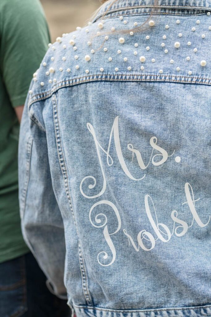 Woman wears jacket that says, "Mrs." on the back of it.