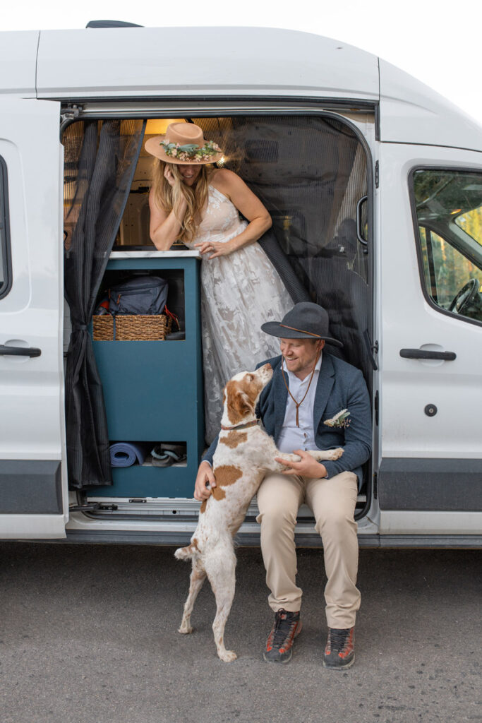 Couple hangs out with their dog in their van after their mountain elopement.