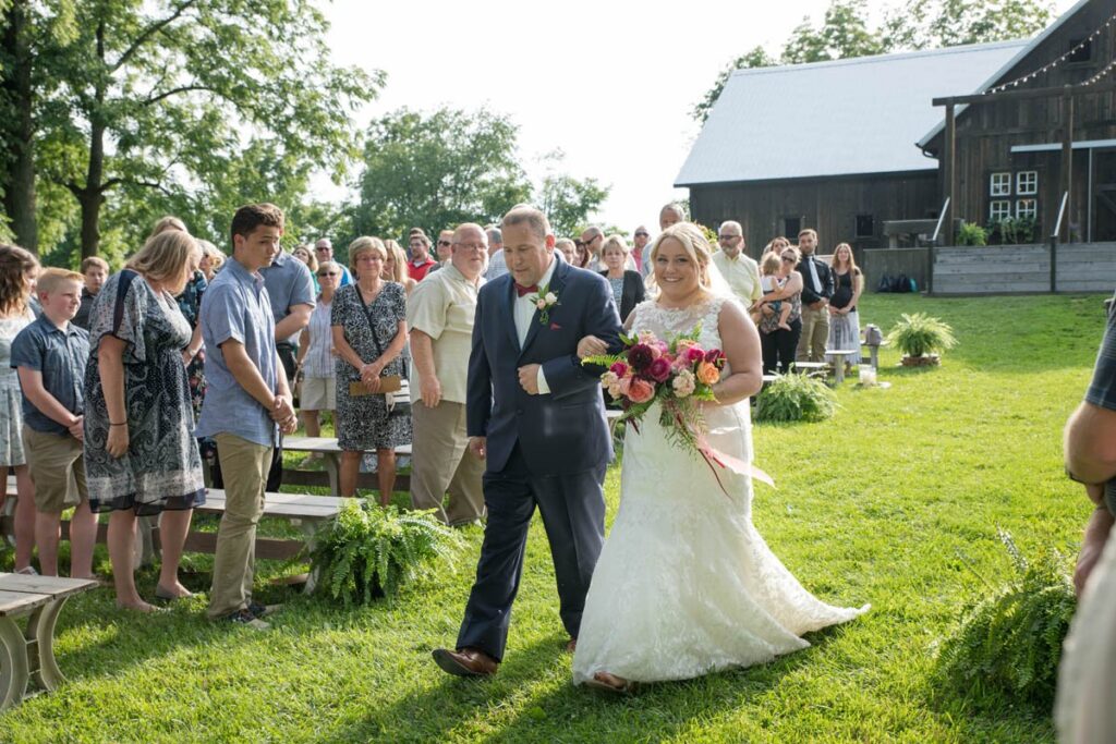 Bride walking down the aisle at Kennedy Estate outdoor wedding ceremony.