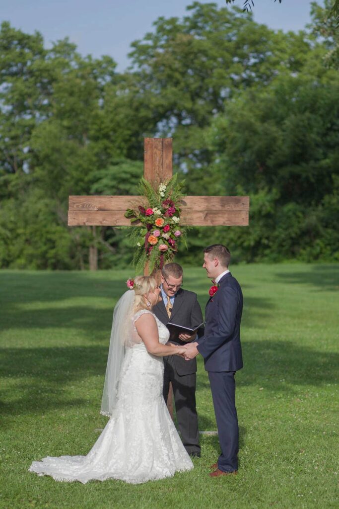 Bride and groom exchanging vows at Kennedy Estate wedding.