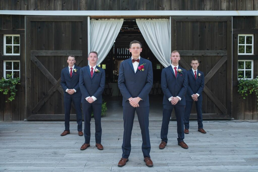 Groom and groomsmen portraits outside of barn at Kennedy Estate wedding.