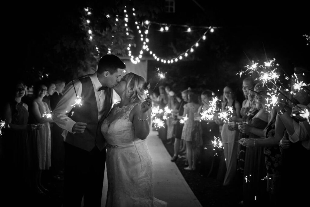 Bride and groom kiss at sparkler exit at Kennedy Estate wedding.