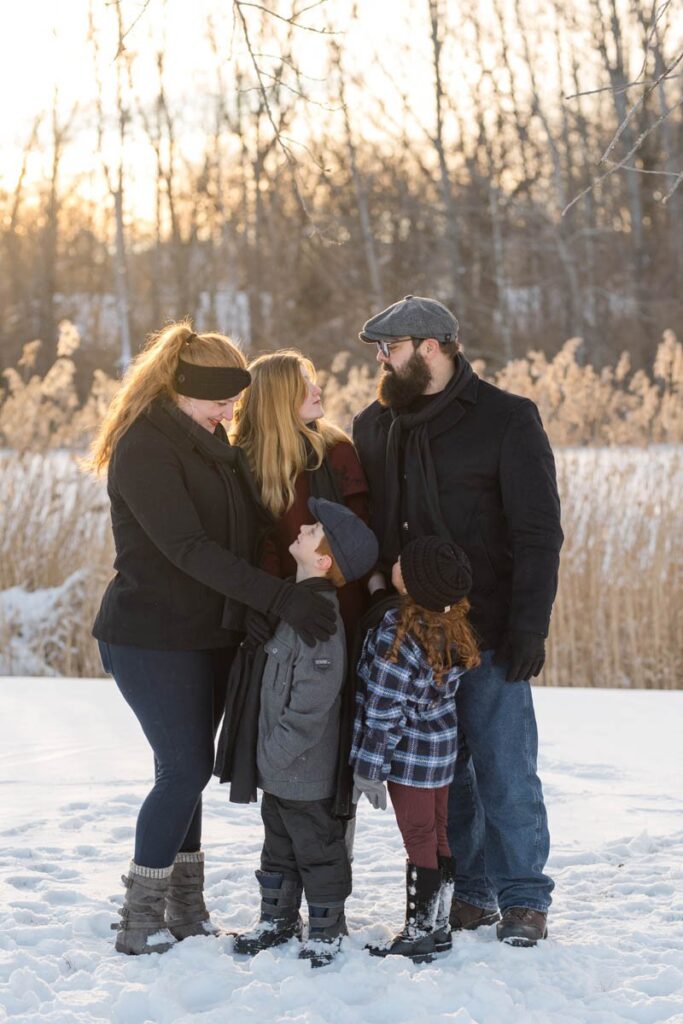 A photoshoot in the snow is chilly so huddling up with your family is a must.
