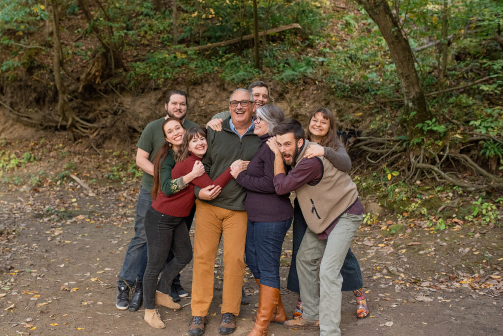 Leave No Trace aware photographer captures family in a big hug during their hiking photo session.