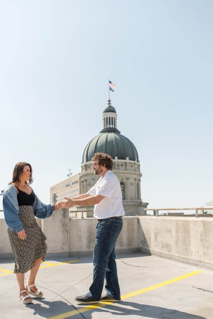 Couple dances together on a rooftop parking garage in Indianapolis.