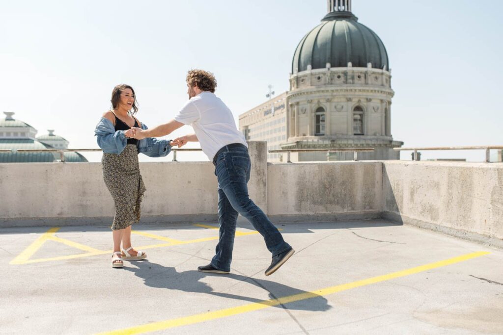 Couple dances on rooftop parking parking garage in Indianapolis.