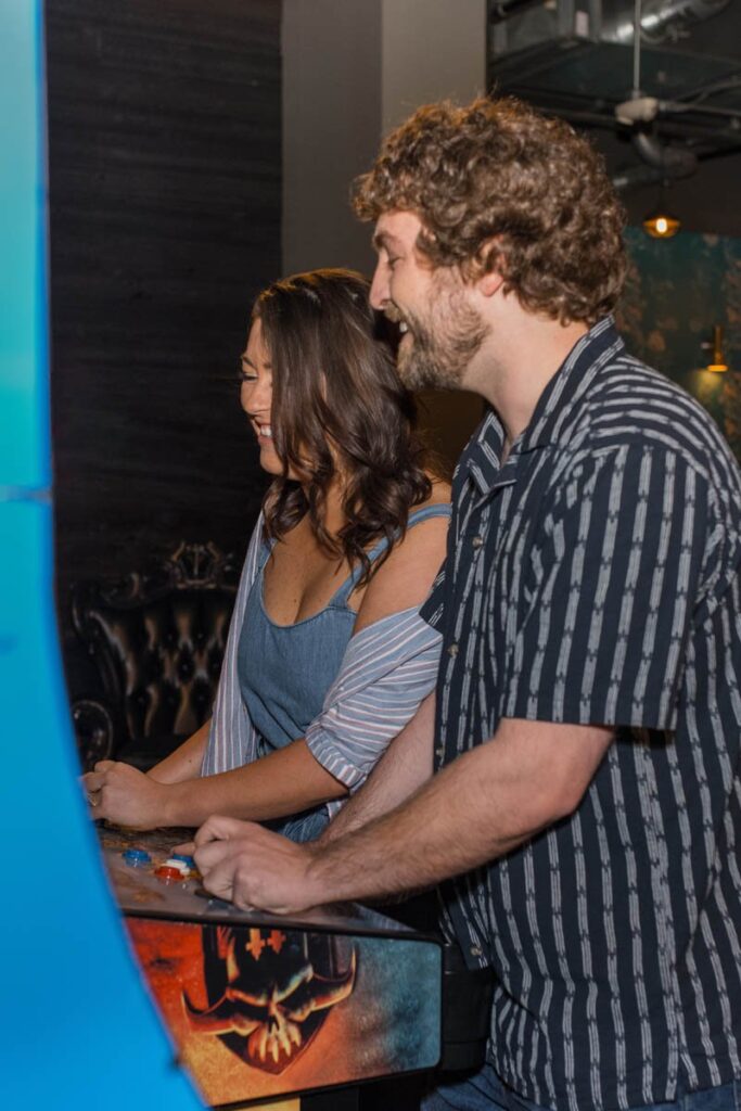 Couple plays arcade games together.