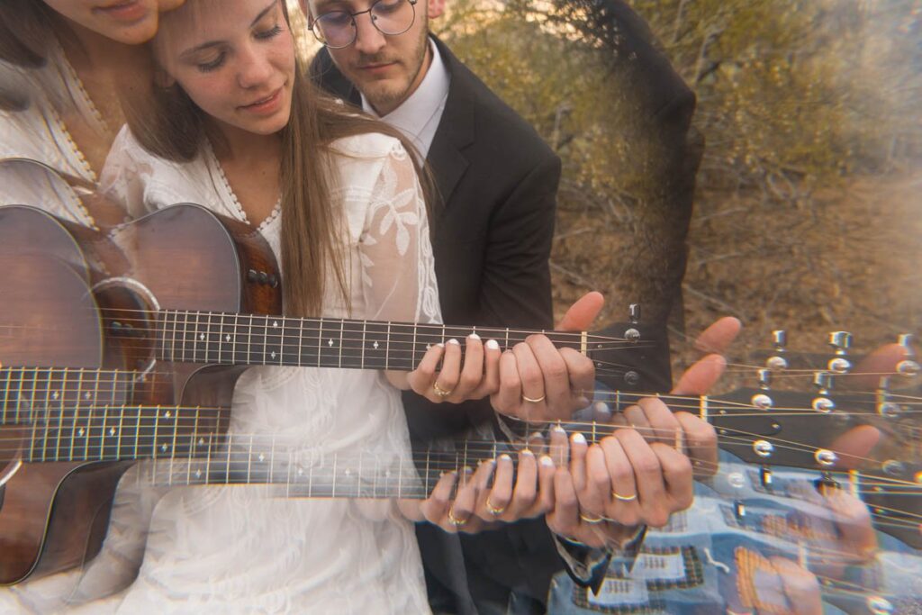 Bride and groom play guitar together with prism effect.