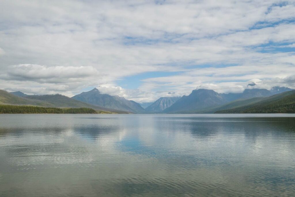 Lake MacDonald with blue sky and clouds above at Glacier National Park.