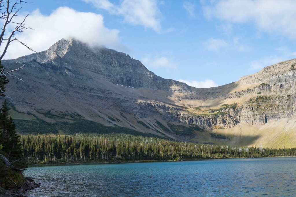 View of large mountain behind Old Man Lake in Glacier National Park.