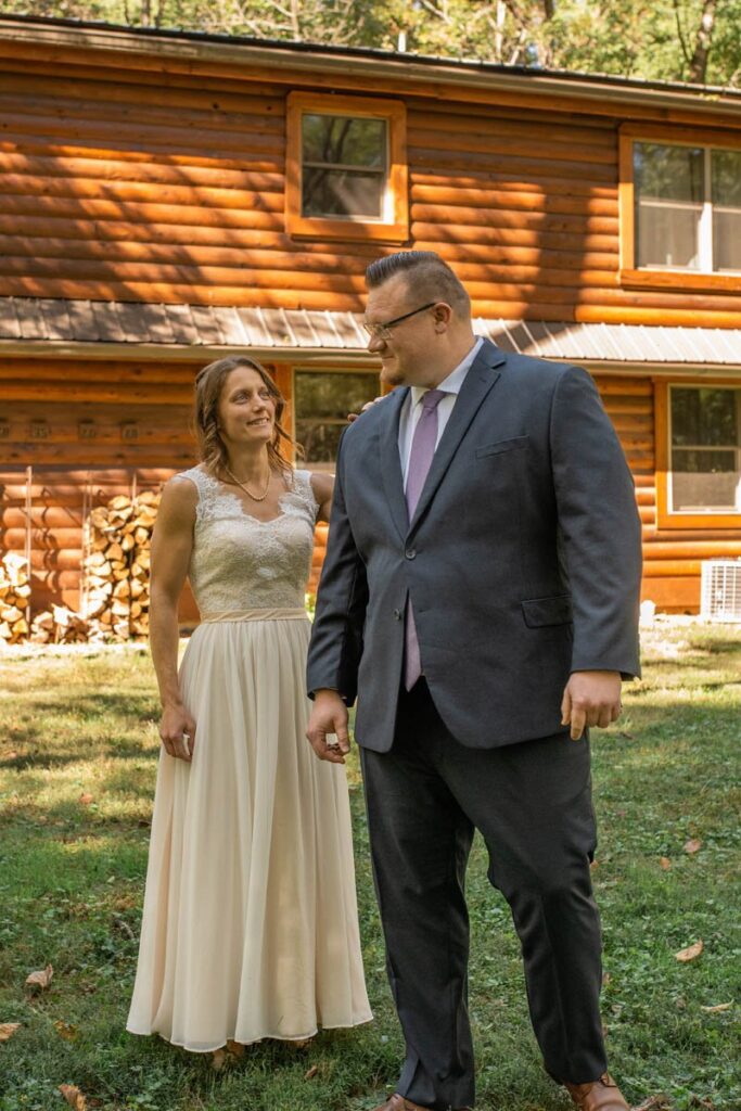 Bride taps groom on the shoulder for their first look at their Indiana elopement.