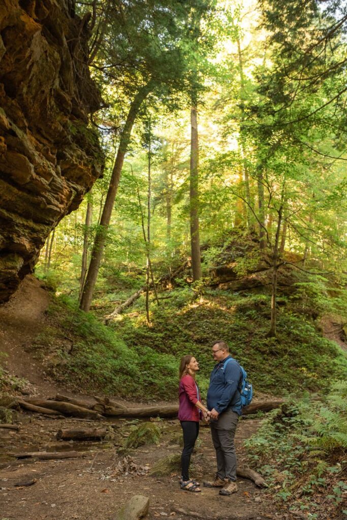 Couple holds hands as they hike at Shades State Park on the morning of their Indiana Elopement.
