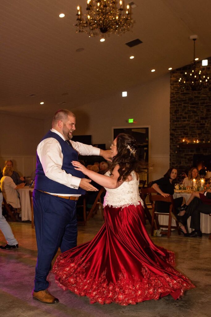 Bride and groom dance happily during their wedding reception.