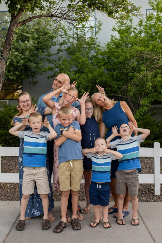 Grandparents make silly faces alongside grandchildren.