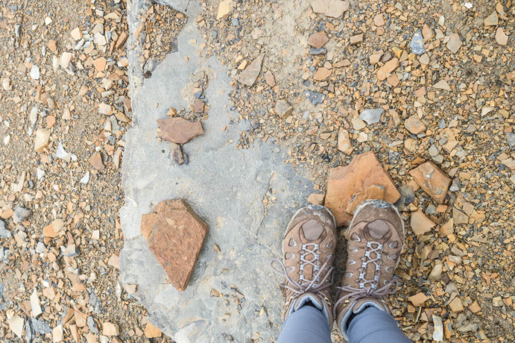 Oboz boots on rocky hiking path in Glacier National Park.