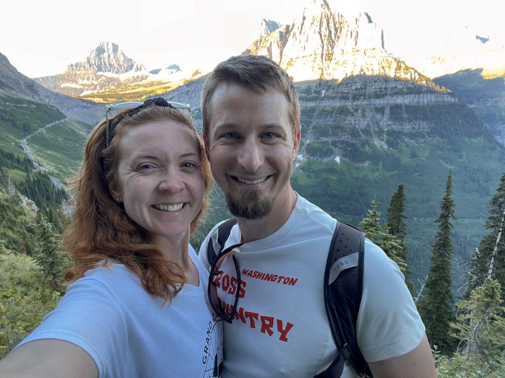 Smiling hikers on trail at Glacier National Park.