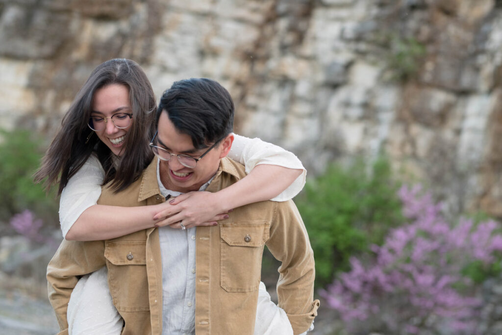 Couple laughing during a piggyback ride.