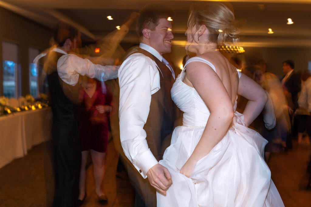 Bride and groom jumping on the dance floor at wedding reception at The Cardinal Room.