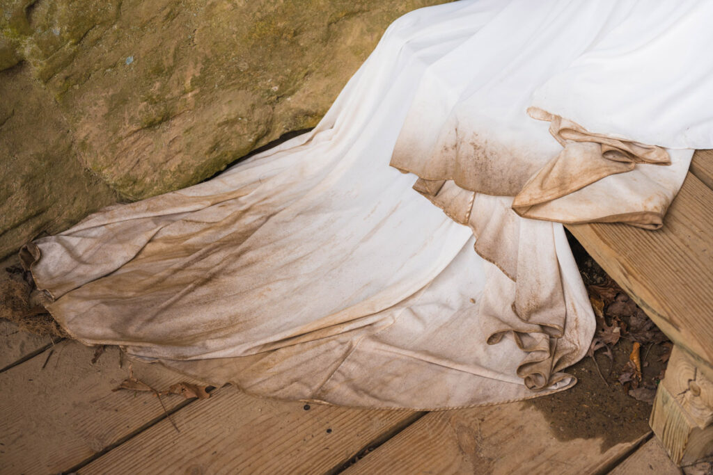 Bottom of bride's dress covered in dirt from elopement hike.