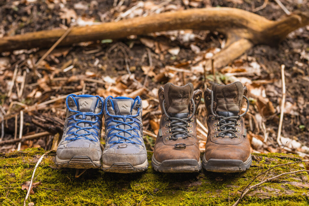 Wedding rings rest on top of hiking boots.