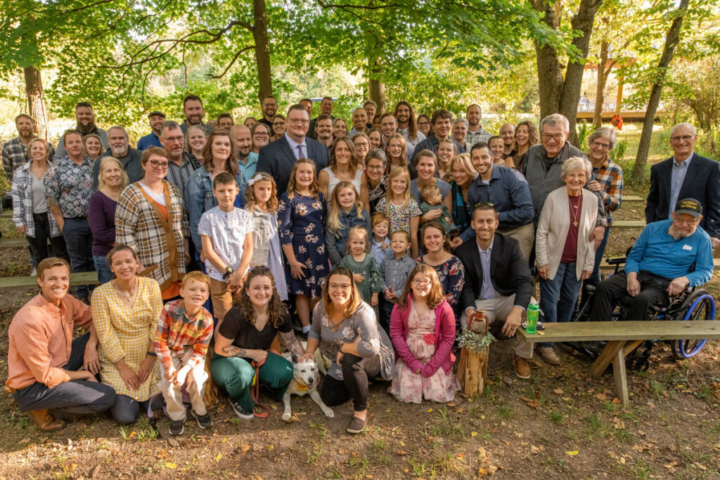 Thinking about how to have an eco-friendly wedding in Indiana means intentionally choosing your guests like this couple with all of their guests after their ceremony.