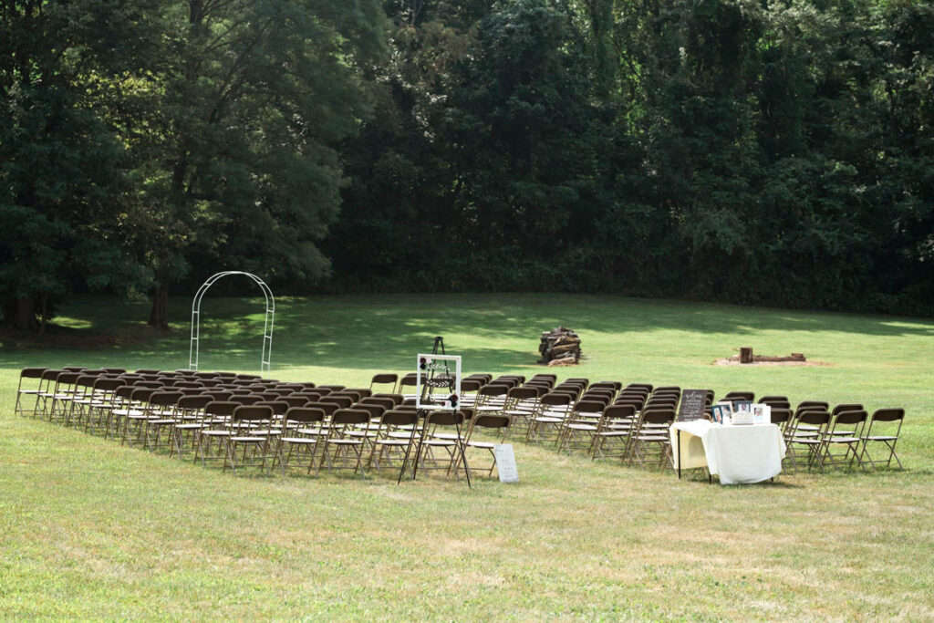 Backyard wedding seating in open grassy area.