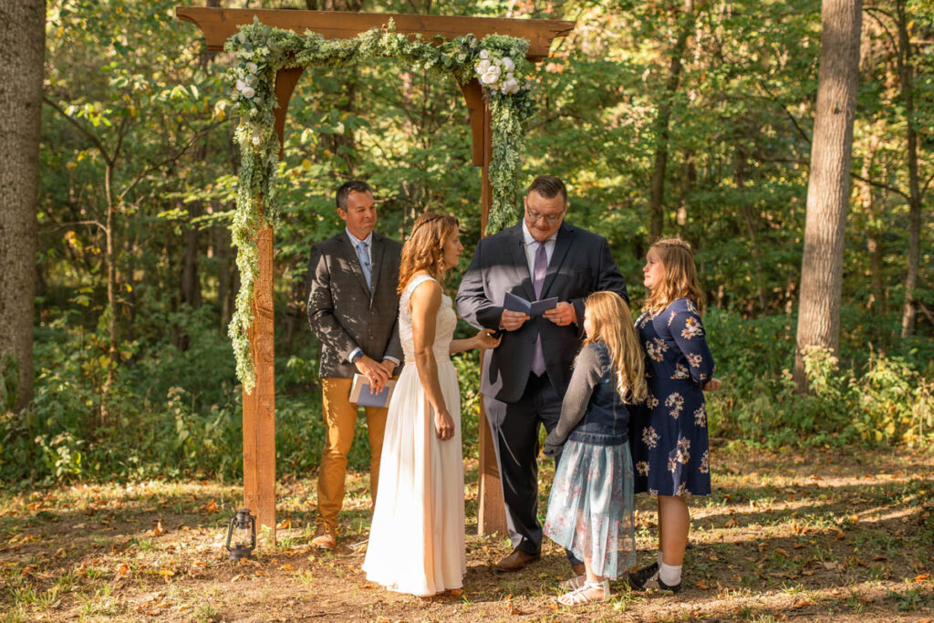 Bride and groom share special vows with their daughters during their outdoor ceremony.
