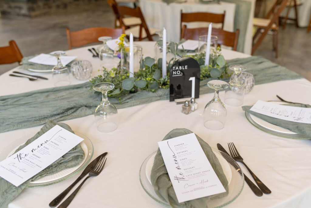 Table setting features reusable dishes and green accent colors.