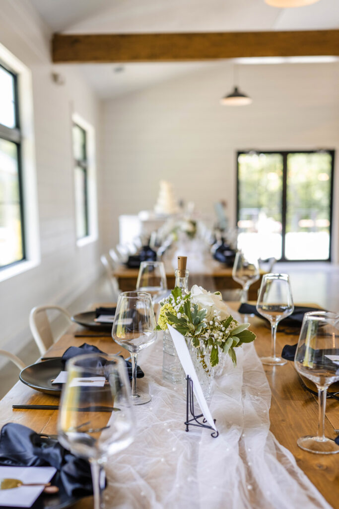 Table seating filled with reusable dishes and rental decor at The Wilds Wedding Venue.